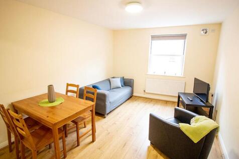 Spacious living room featuring a cozy sofa, sty...