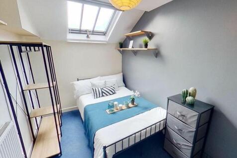 This inviting double bedroom features a cozy la...
