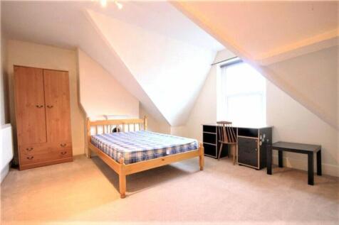 Spacious double bedroom featuring ample natural...