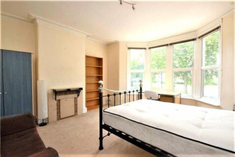 This spacious double bedroom features large win...