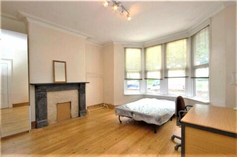 This charming double bedroom features large bay...