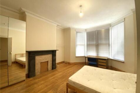 Spacious double bedroom featuring large windows...