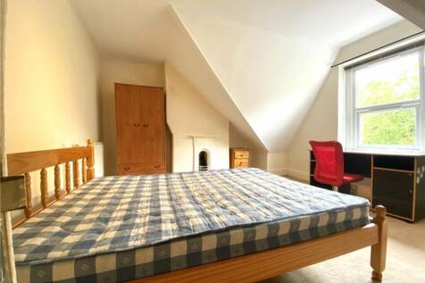Spacious double bedroom featuring ample natural...