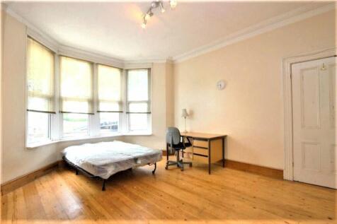 This spacious double bedroom features large win...