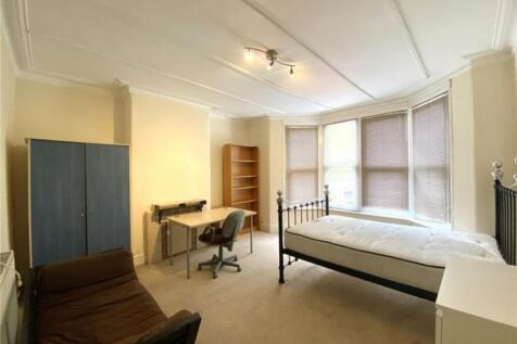 Spacious double bedroom featuring large windows...