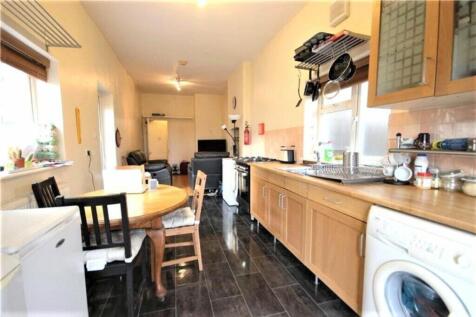 A spacious kitchen featuring a dining area, per...