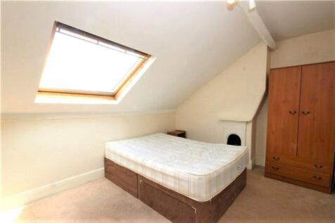 This charming double bedroom features a cozy at...