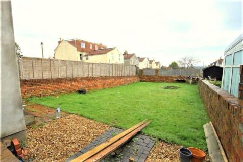 A spacious garden area featuring a lush green l...
