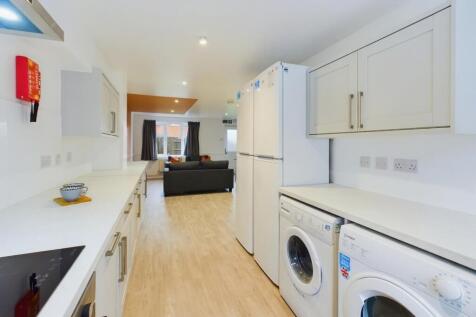 A spacious and modern kitchenette with ample st...