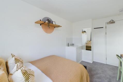 A bright and inviting double bedroom featuring ...