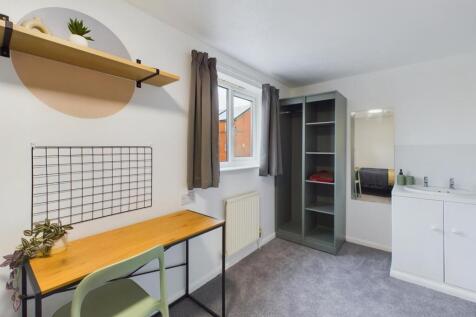 A well-lit and tidy double bedroom featuring a ...