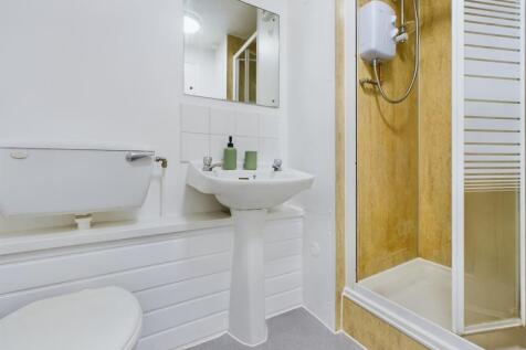 A bright and tidy bathroom featuring a modern s...