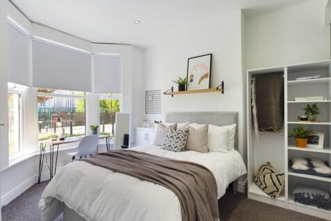 A bright and inviting double bedroom with moder...
