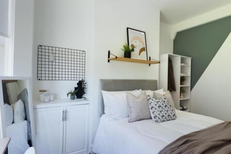 A bright and inviting double bedroom with moder...