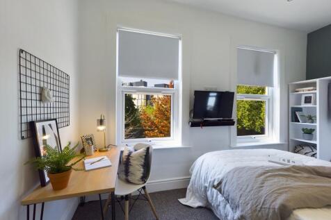 A bright and inviting double bedroom featuring ...
