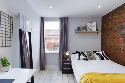 A stylish and well-lit double bedroom featuring...