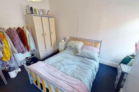 Cozy double bedroom featuring a comfortable bed...