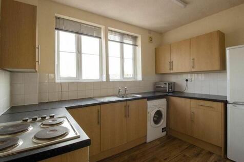 Spacious kitchen area featuring modern cabinetr...