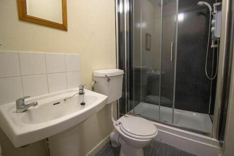 This well-maintained bathroom features a modern...