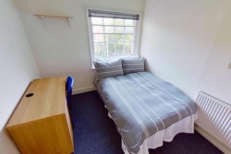 This inviting double bedroom features a comfort...