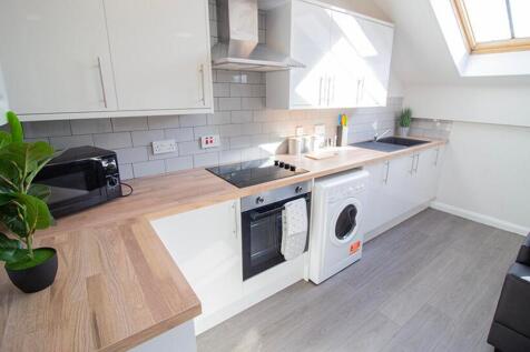 This modern kitchen features sleek cabinetry, a...