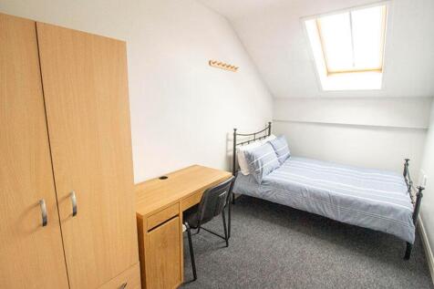 This inviting double bedroom features a comfort...