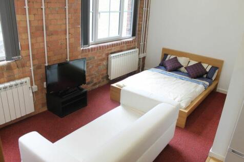 This inviting double bedroom features a cozy be...