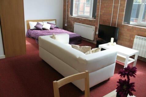 A stylish double bedroom featuring a cozy bed a...