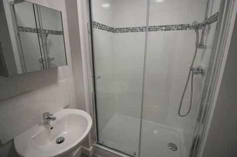Bright and modern bathroom featuring a walk-in ...