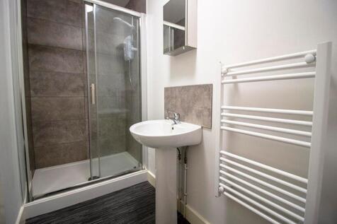 Modern bathroom suite featuring a sleek shower,...