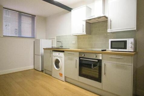 Modern kitchen featuring sleek cabinets, a spac...
