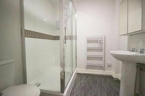 A sleek and modern bathroom featuring a spaciou...