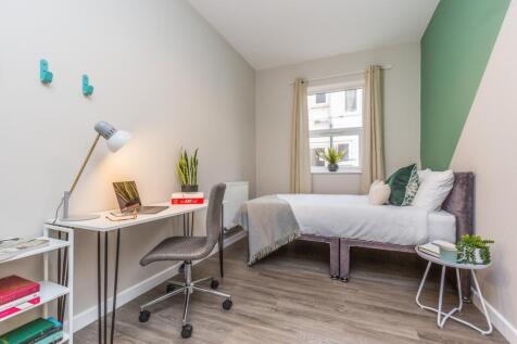 A bright and inviting double bedroom featuring ...