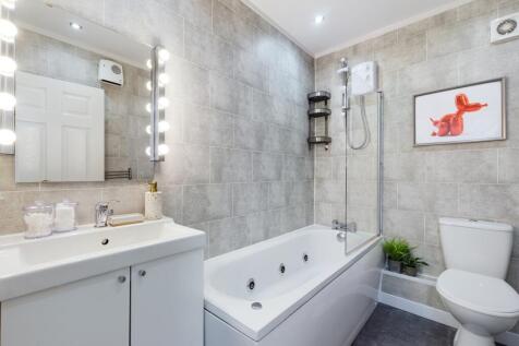 A spacious and modern bathroom featuring a luxu...