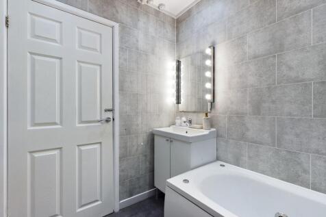 A modern and spacious bathroom featuring a styl...