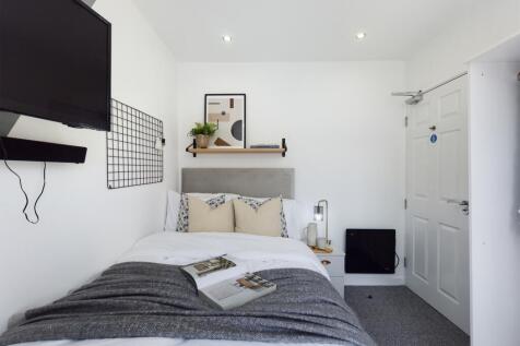 A bright and stylish double bedroom featuring m...