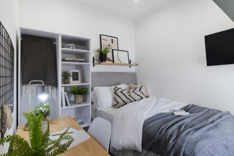A stylish and well-organized double bedroom wit...