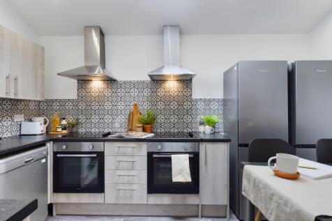 A modern and spacious kitchen featuring stylish...