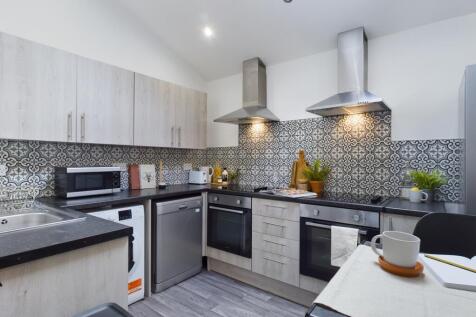 A modern and stylish kitchen featuring sleek ap...