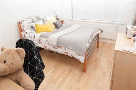 This inviting double bedroom features a comfort...
