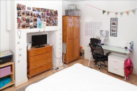 This inviting double bedroom features a cozy wo...