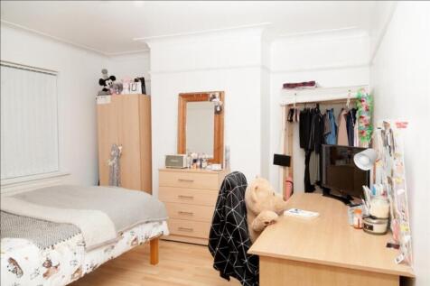 This inviting double bedroom features a cozy be...