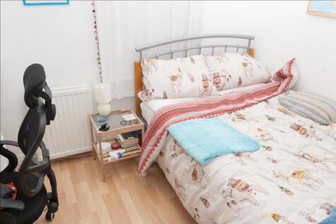 Cozy double bedroom featuring a comfortable bed...