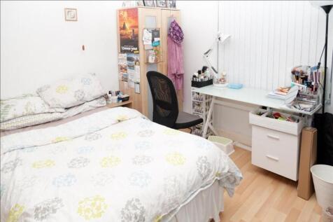 This inviting double bedroom features a cozy la...