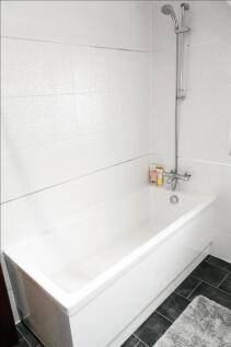 This modern bathroom features a sleek bathtub a...