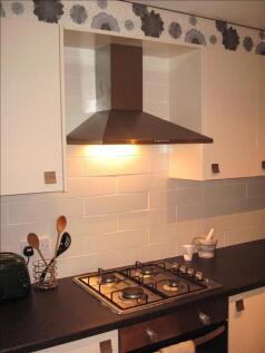 A modern kitchen featuring sleek cabinets and a...