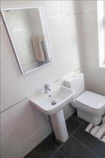 Bright and modern bathroom featuring sleek fixt...