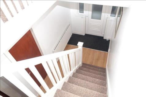 A well-maintained staircase featuring a clean a...