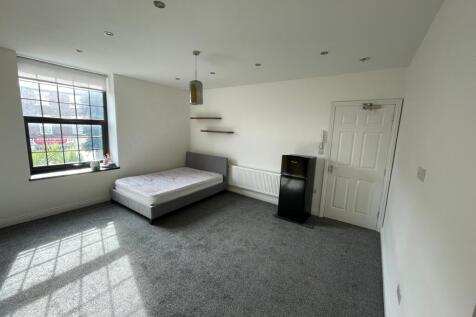 Spacious double bedroom featuring large windows...