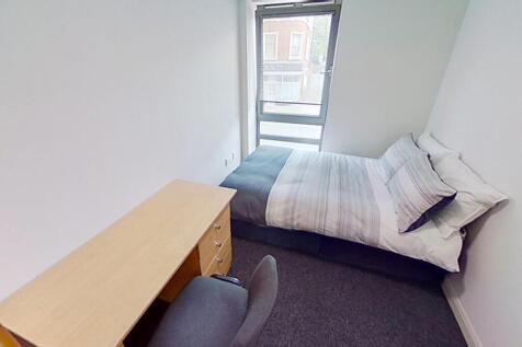 This inviting double bedroom features a cozy la...